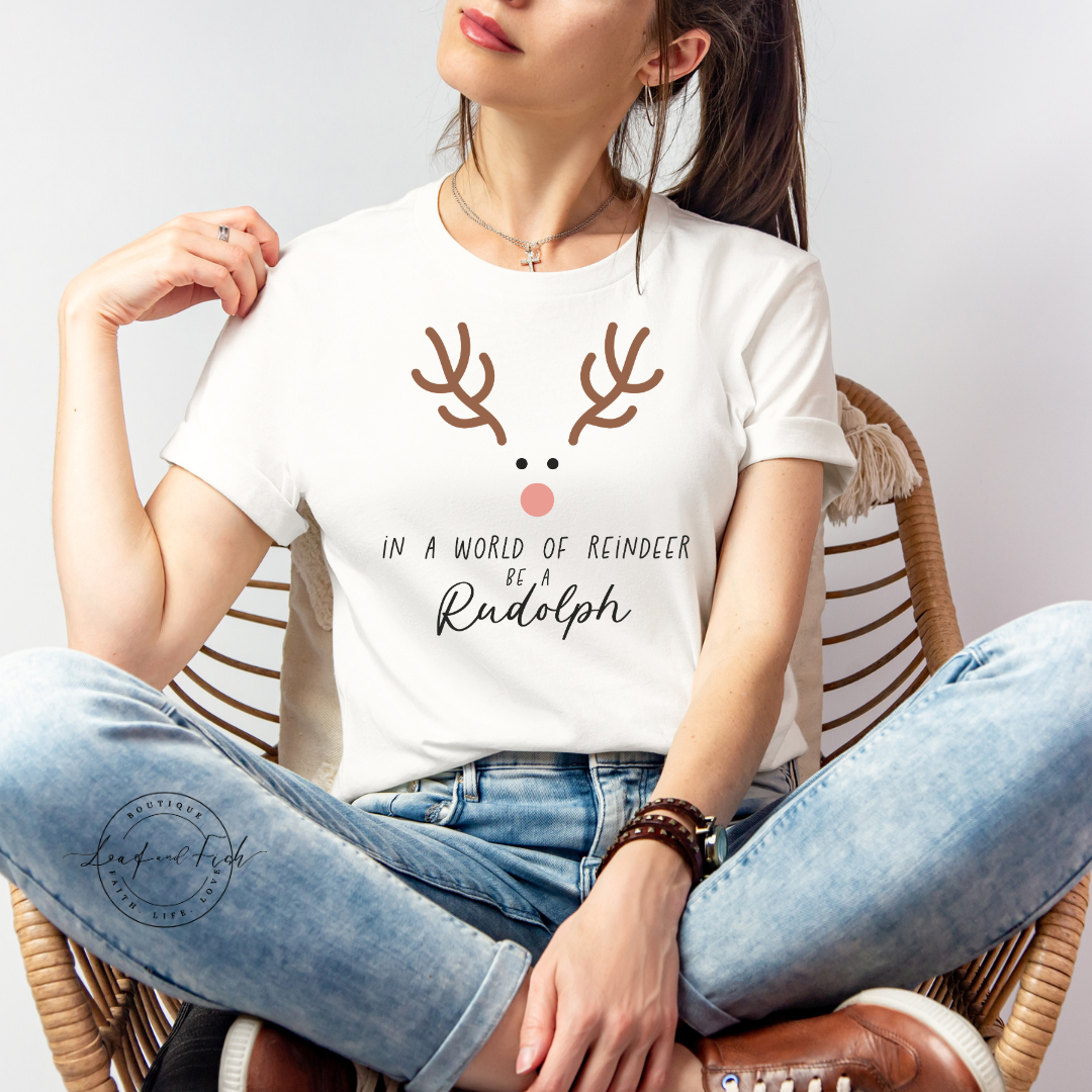 IN A WORLD OF REINDEER BE A RUDOLPH - Christian Unisex T-shirt