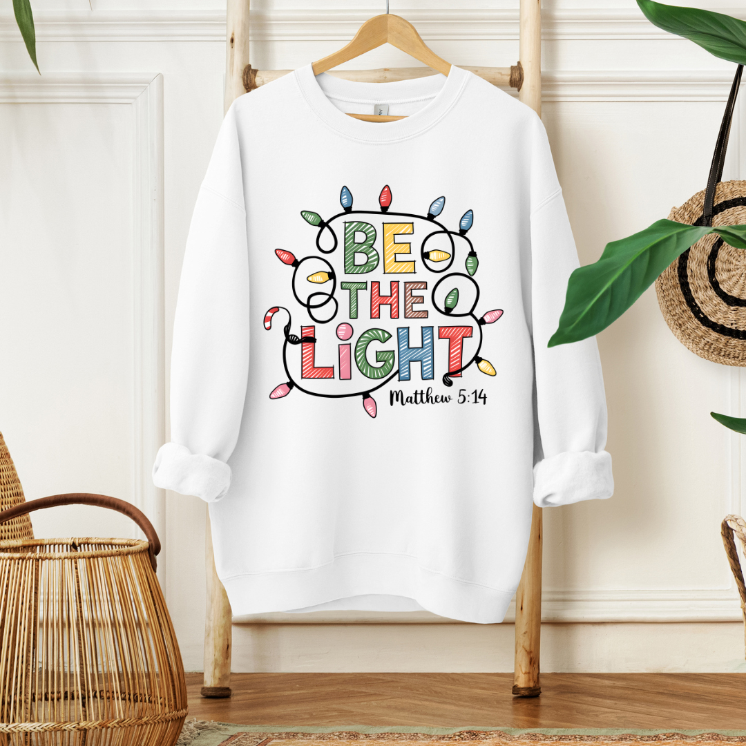 BE THE LIGHT- Christian Unisex Sweater